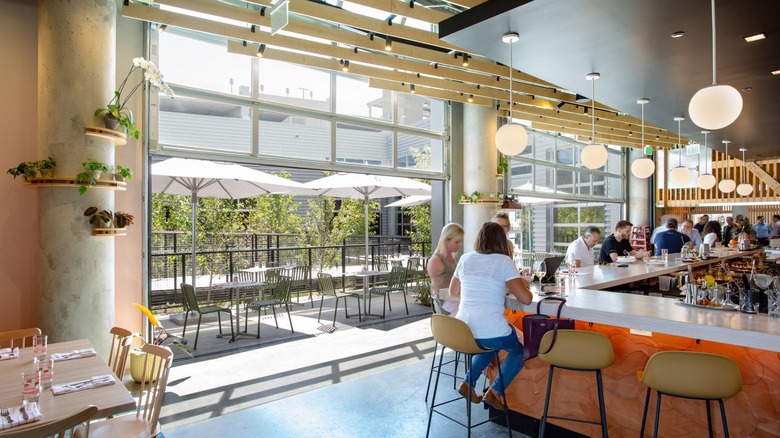 Patrons dining at Safta, a restaurant in The Source Hotel + Market Hall in Denver, Colorado