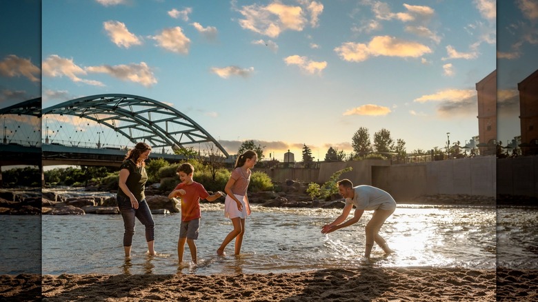 Family playing in the South Platte River in Denver's Confluence Park