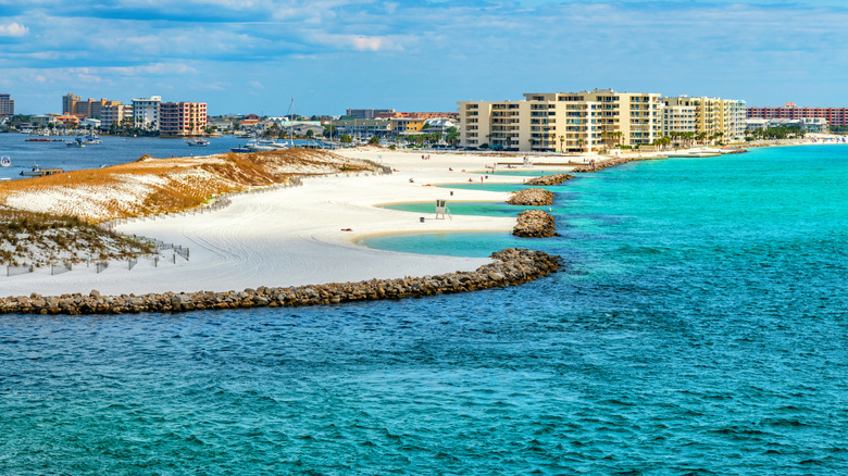 White sandy beaches with Destin, Florida in the background.