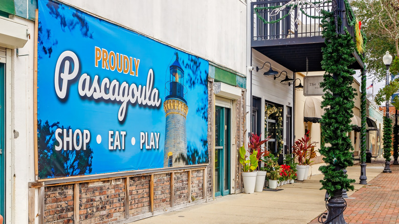Downtown Pascagoula, Mississippi storefronts with a "Proudly Pascagoula" sign on the side of a building