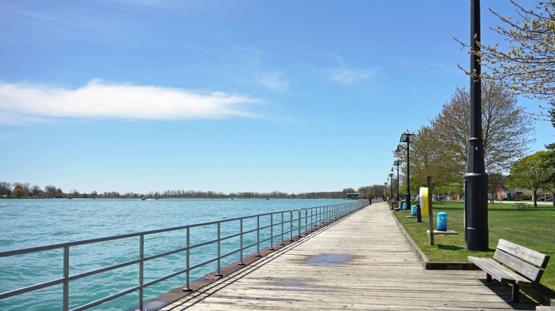 A view of the St Clair River from the benches, grass, and boardwalk at Algonac Waterfront Park.
