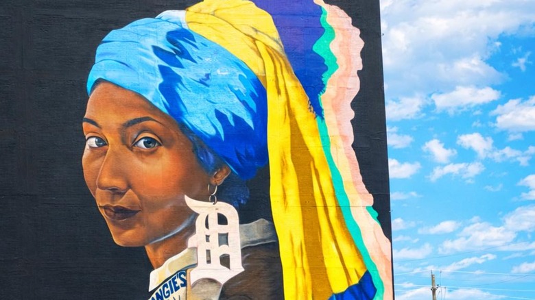 A mural of a woman with a "D" earring for Detroit
