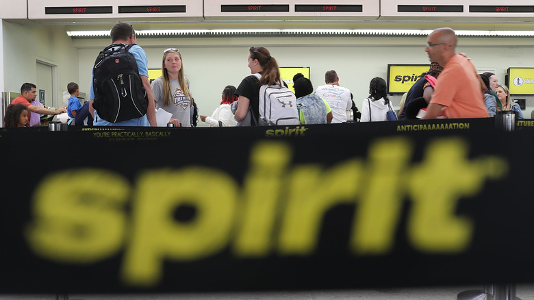 Passengers waiting in line at Spirit Airlines counters in the airport