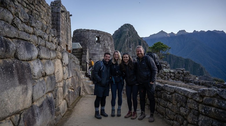 four friends at the end of the Inca Trail at machu Picchu