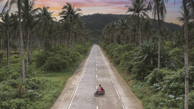 A biker on an empty road in Siargao, Philippines
