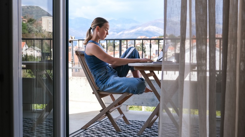 Woman working against a backdrop of mountains