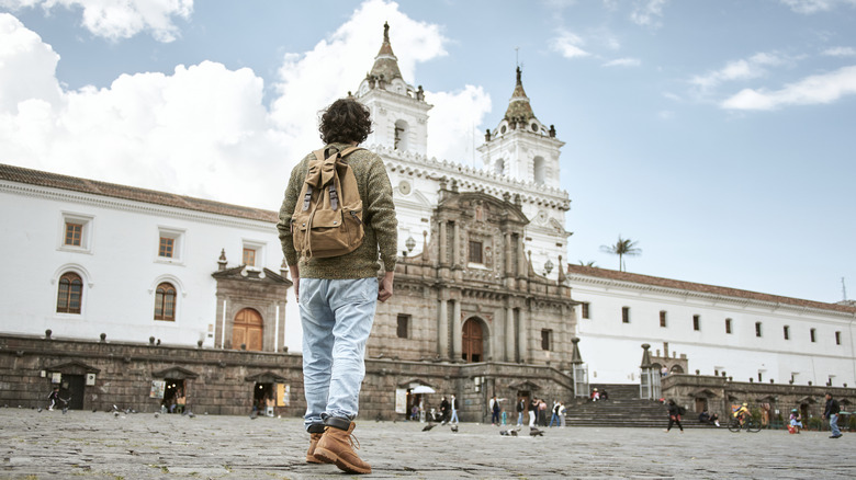 View of a man standing in a plaza in Quito, Ecuador
