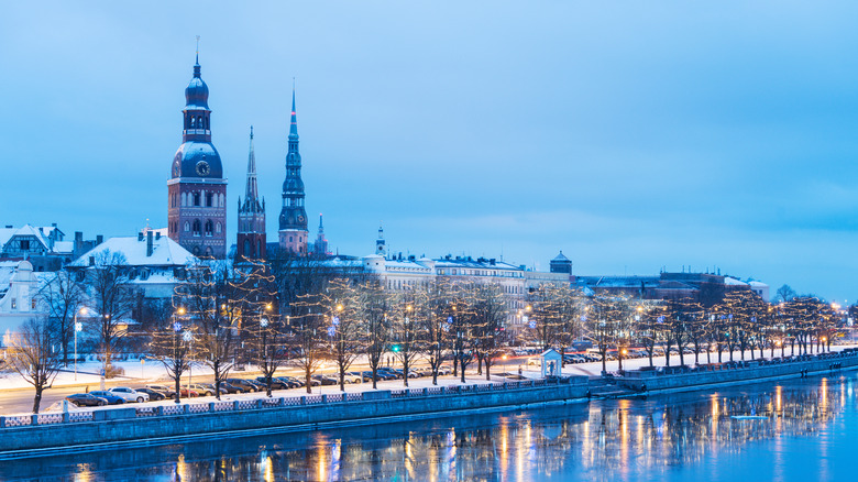 A snowy European city with seasonal lights
