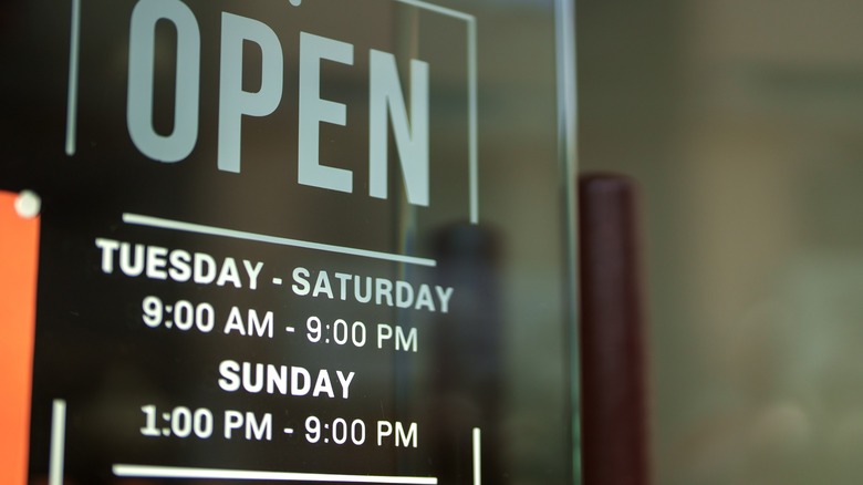 An open sign with operating hours