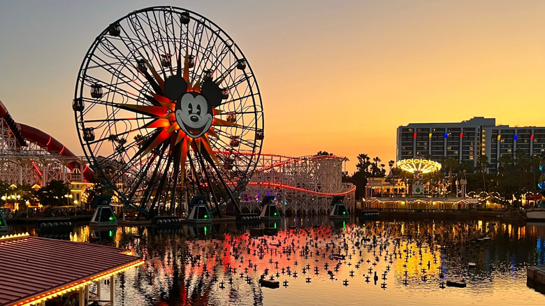 View of the Ferris wheel and various rides at Disneyland, a theme park complex based in Anaheim, California, USA, pictured here at sunset