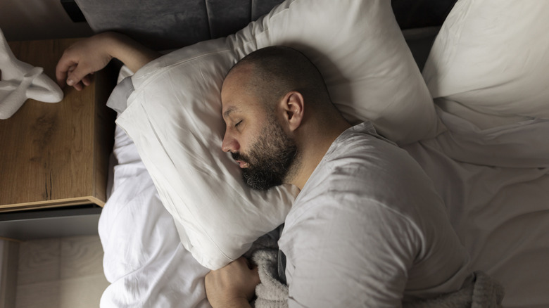 Someone sleeping peacefully in a hotel room