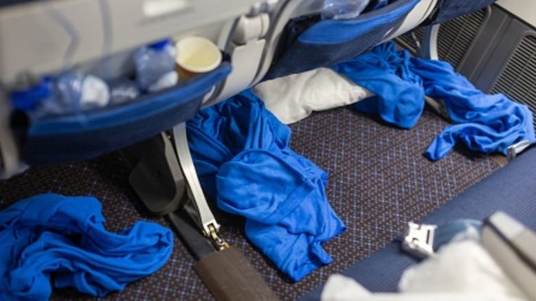 Trash and mess left behind by passengers on a flight