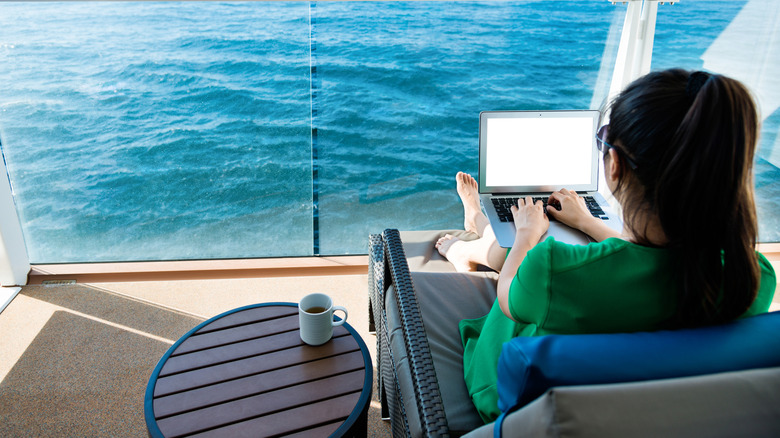 A woman using her laptop on a cruise ship