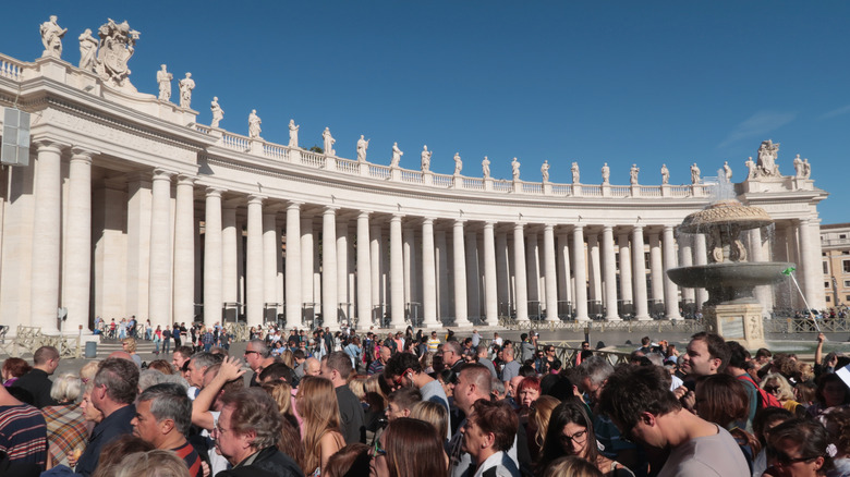 Crowds of people visiting St. Peter's Basilica