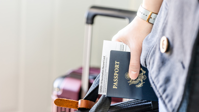 hand holding passport at airport