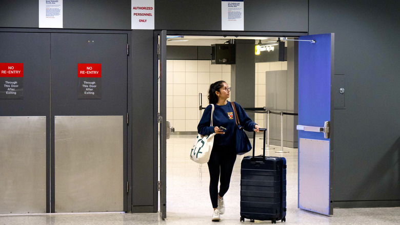 A woman walking through customs in the U.S.