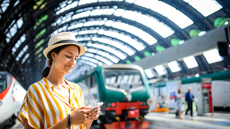 smiling person at a train station