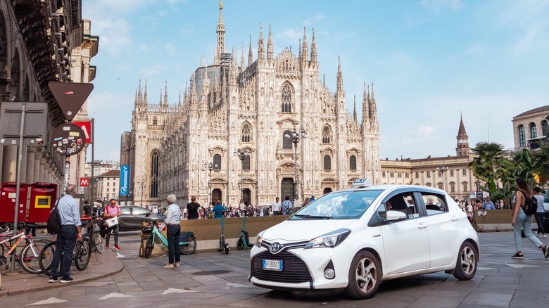 a car parked in front of a Milanese cathedral