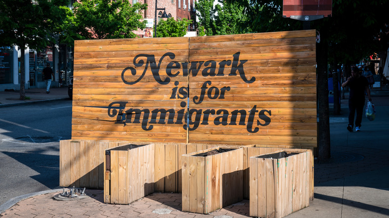 Wooden sign on Ferry Street that says "Newark is for Immigrants" in Newark, NJ