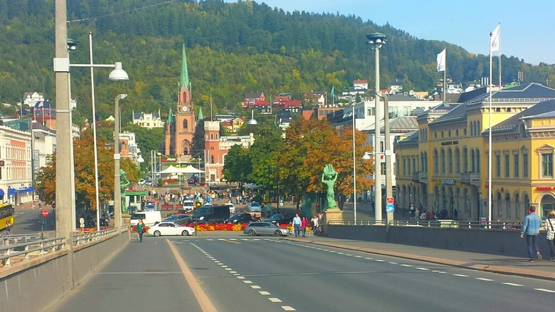 A downtown view of Drammen, Norway as seen from the bridge looking toward a church and buildings