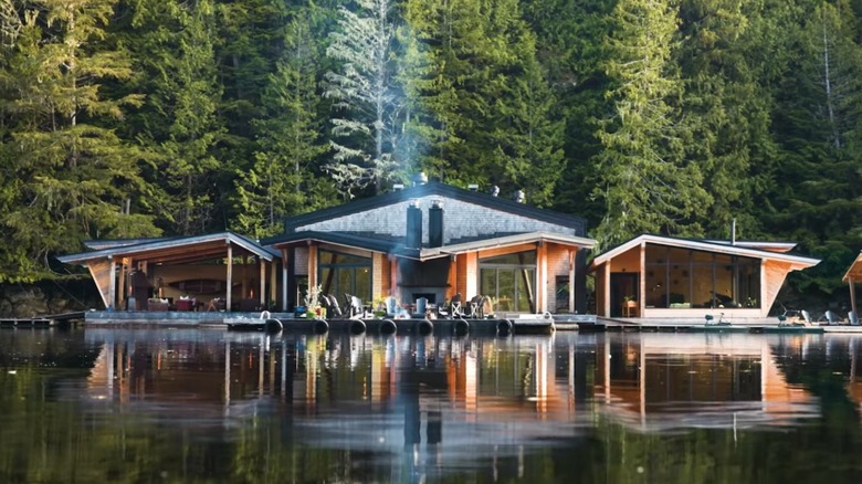 Restaurant and lounge overlooking the water with trees behind them at Nimmo Bay Wilderness Resort, British Columbia