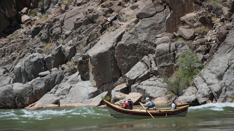 People in a canoe on the Colorado River at the end of Diamond Canyon Road in Arizona