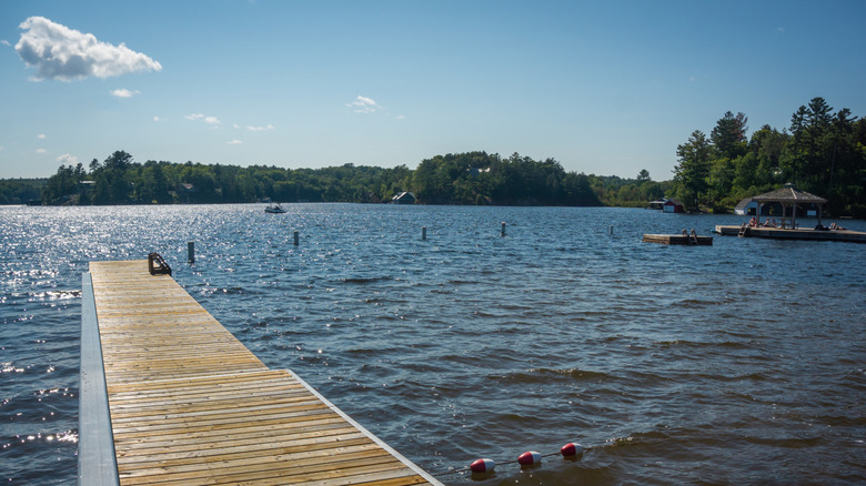 A wooden jetty pokes out onto Lake Rosseau, Ontario