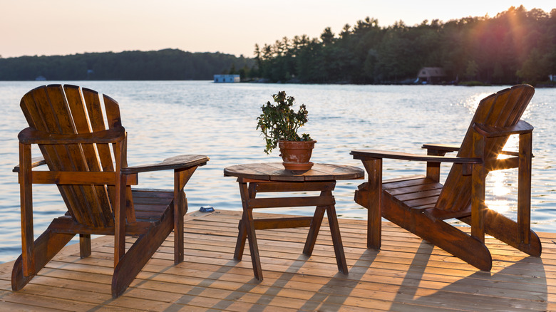 Chairs sit on a deck on the side of Lake Rosseau