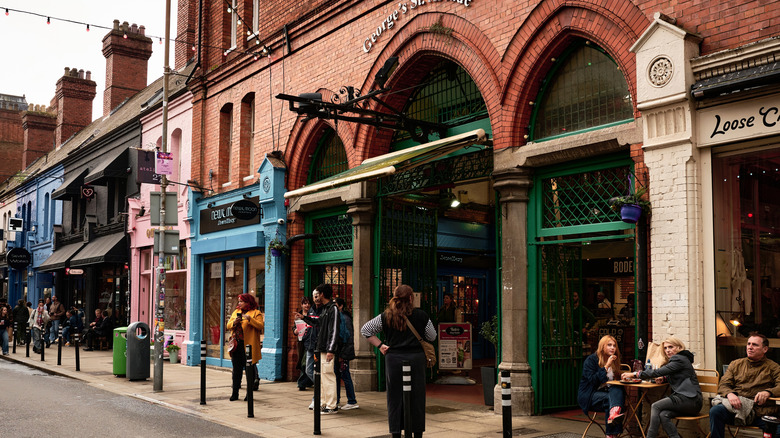 George's Street Arcade entrance on Drury Street, Dublin, with people and colorful shops