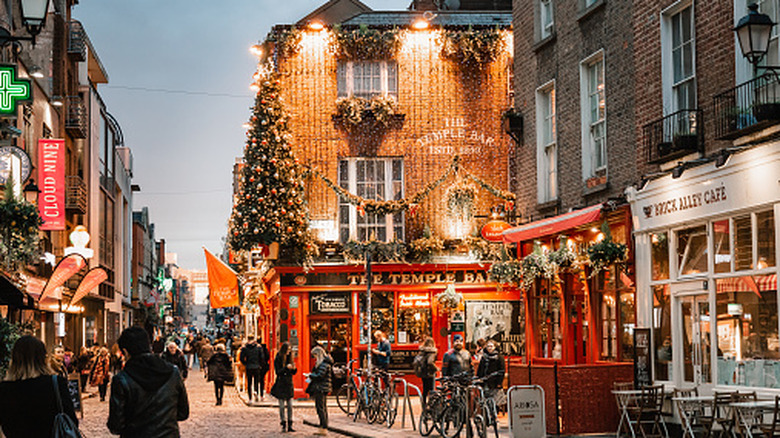 Dusk view of Temple Bar District, Dublin, lit up with fairy lights, with the famous Temple Bar Pub in the center
