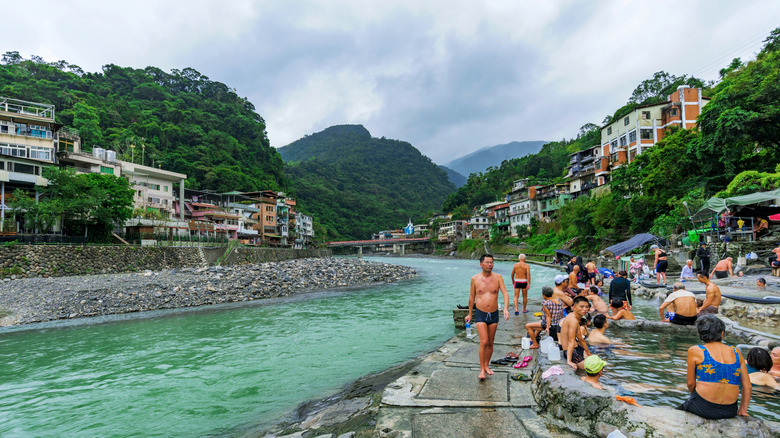 Visitors to Wulai enjoy the riverside hot spring pools