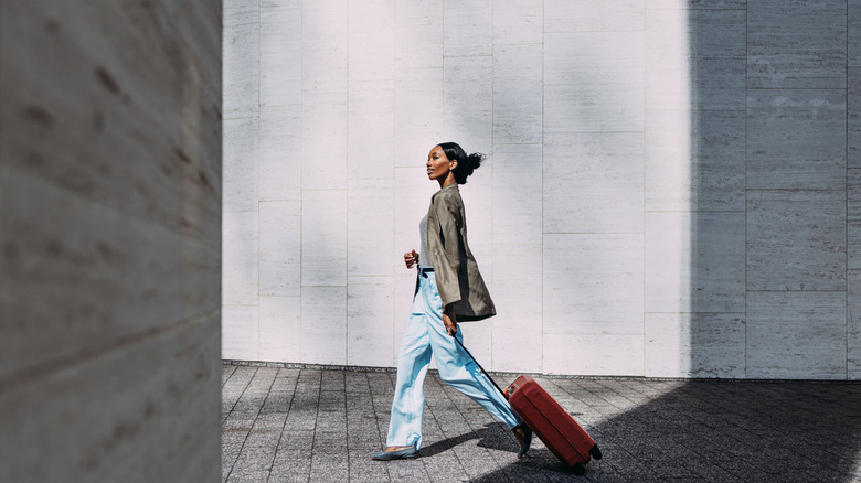 Woman walking with suitcase