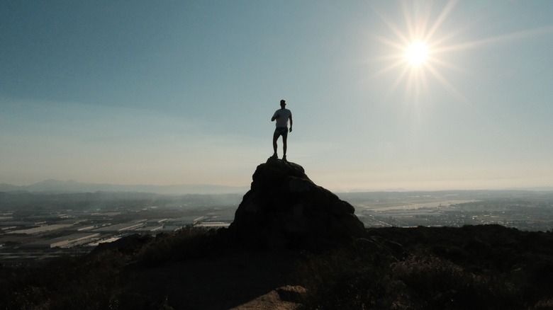 Man posing on top of Terri Peak at Lake Perris State Recreation Area, California