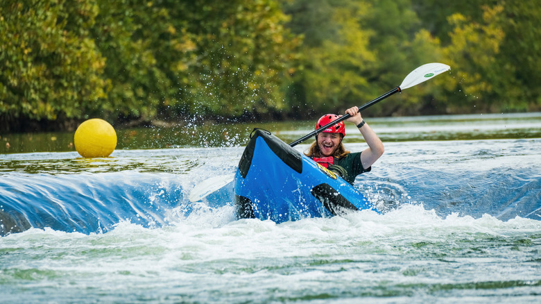 A man in a raft Going over the whitewater at Eastwood Metropark, Dayton, Ohio, on the Mad River