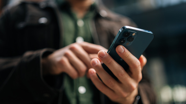Man using a blue iPhone