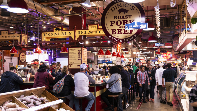 Inside the Reading Terminal Market, with the DiNic's sign in the center and crowds navigating stalls