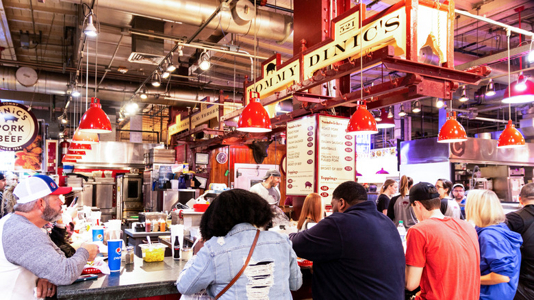 DiNic's in Reading Terminal Market, with its counter full of patrons under an industrial ceiling