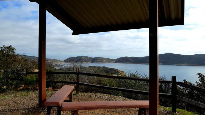 Bench and viewing area above blue lake in Elfin Forest Recreational Reserve