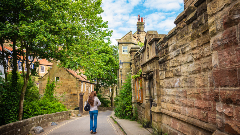 Woman walking through Robin Hoods Bay in North Yorkshire
