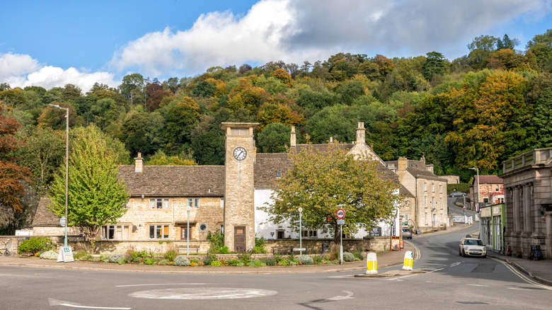 A charming clock tower, cottages, and trees in Nailsworth in the Cotswolds