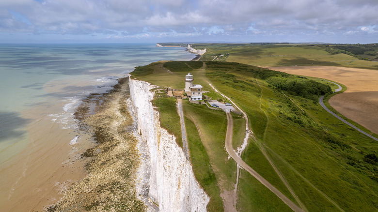Aerial view of Belle Tout Lighthouse atop chalk cliffs on the English South Coast