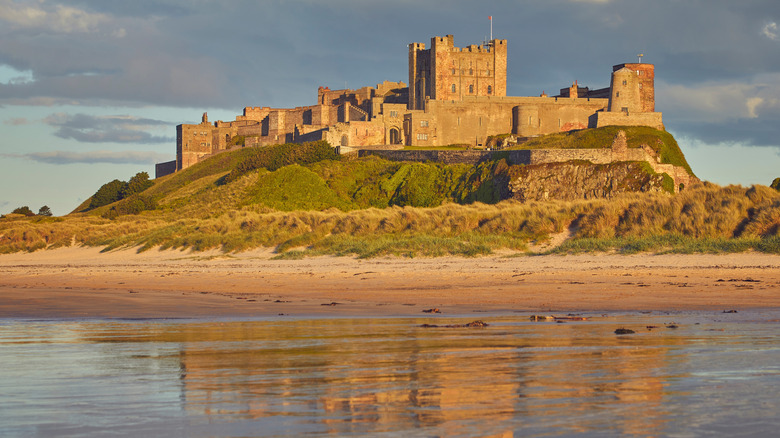 Bamburgh Castle above dunes of Bamburgh Beach
