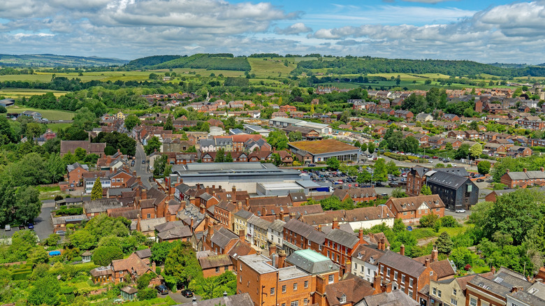 Aerial photo of buildings. trees. and green hills in the picturesque town of Ludlow