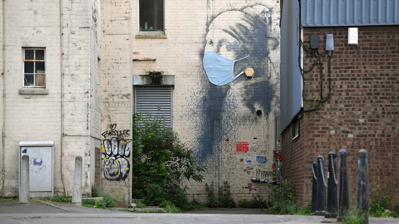 The Girl with a Pierced Eardrum painted on a building in Bristol, England, by graffiti artist Banksy