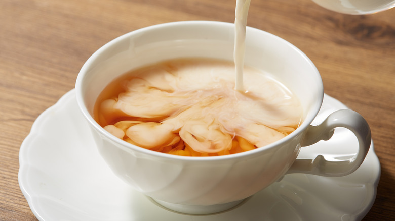 Pouring milk into tea