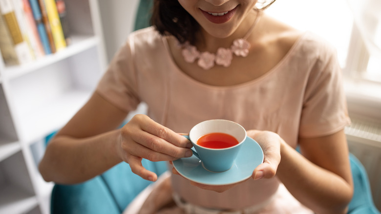 Woman drinking tea with pinky out