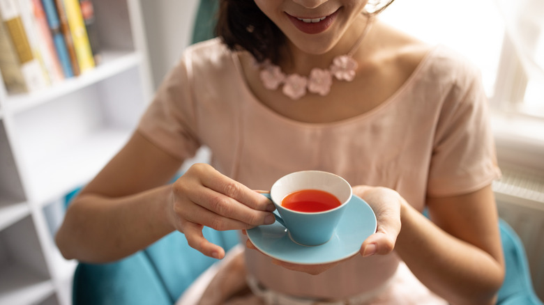 Woman drinking tea with pinky out