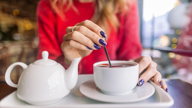 Woman stirring a teacup