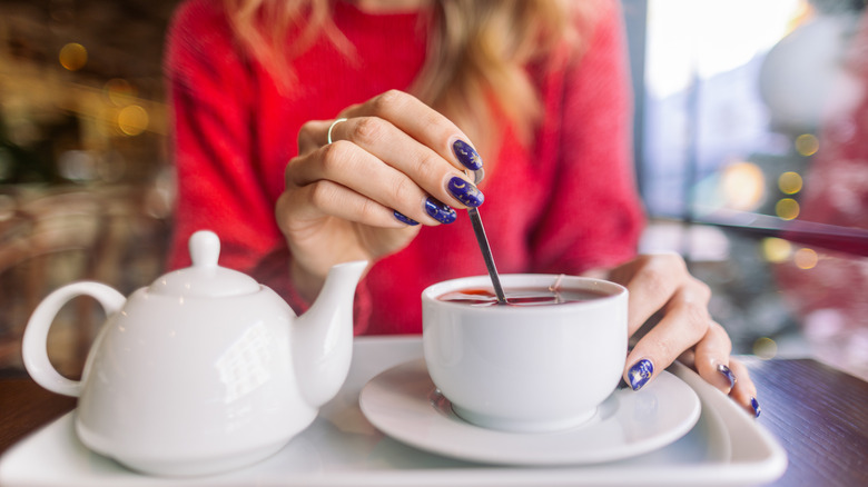 Woman stirring a teacup