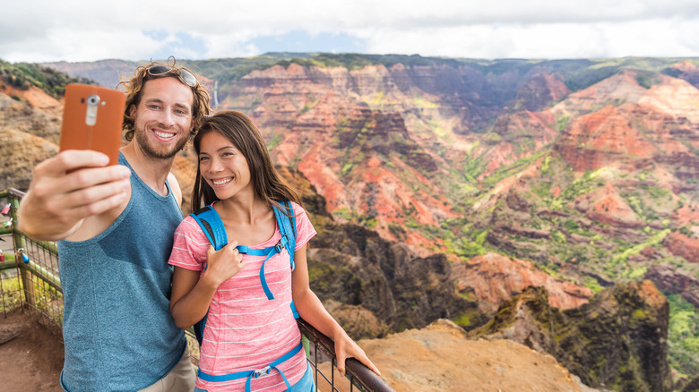 Couple taking photos at Waimea Canyon